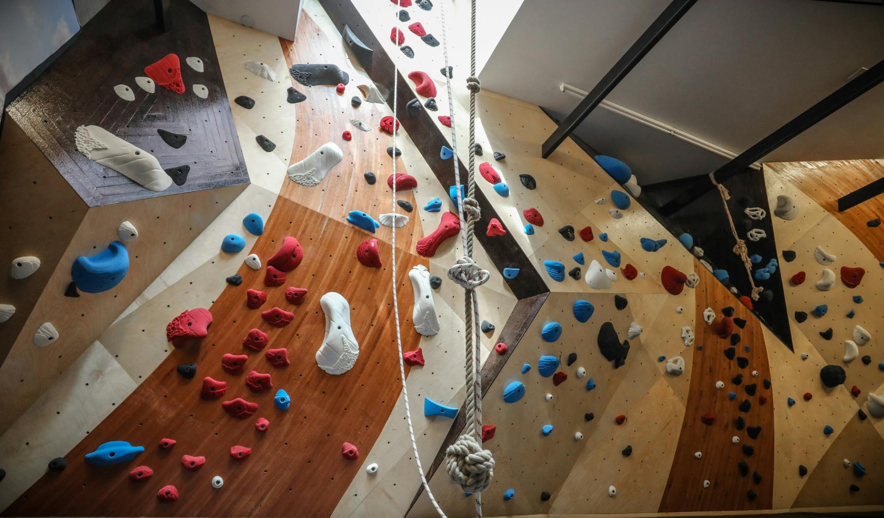 Wood climbing wall in private home with rope climb